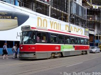The north-east corner of Yonge and Dundas has traditionally been a magnet for shooting streetcars <a href=http://www.railpictures.ca/?attachment_id=47401><b>over the years</b></a>, both due to its proximity to the Eaton Centre, the busy Yonge-Dundas Square tourist destination, and being a transfer point to/from the Dundas Subway Station on the Yonge line just below.<br><br>Here's the 2006 view of what the location looked like: TTC CLRV 4174 on the 505 Dundas loads passengers in front of the large blue construction hoarding that had been erected along the NE corner where the old <a href=http://www.railpictures.ca/?attachment_id=38026><b>Brown Derby Tavern building</b></a> once was (it had been renovated to <a href=http://www.railpictures.ca/?attachment_id=31453><b>house various commercial shops</b></a> in the 70's). It was demolished a few years earlier for a new grand commercial development known at the time as "Metropolis", since renamed "10 Dundas East" and now "The Tenor".<br><br>The eastern potion was built over and around the old Ryerson University parking garage and bookstore. The university green-lit the development over their property in exchange for being allowed to use the movie theatres inside the <a href=http://www.railpictures.ca/?attachment_id=43><b>AMC</b></a> theatre as lecture halls for holding classes during the afternoons and off-peak hours. Just flash your handy-dandy Ryerson ID to get in, but the fun ended there as there weren't any movies playing during the off-hours. Some <a href=http://www.railpictures.ca/?attachment_id=16283><b>shops</b></a> started opening during 2007 when most of the building was nearing completion.<br><br>Another sign of the times: this view pre-dates any Google Streetview images showing the big blue hoarding and construction. Glad I carried a camera around most days, back before cellphone cameras were mature enough.