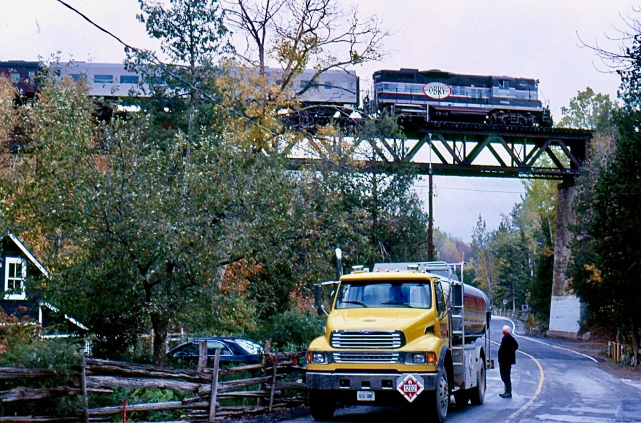 For a few years I made the effort to go out mainly for the fall and winter “Credit Valley Explorer” trains. It was hard to take a bad photo on most of the line with its scenery and deep history. Definitely one of the lines in Southern Ontario I miss the most today. One by one the branchlines that connected to the subdivision vanished into history and freight traffic went on a steady decline well after passenger service ended. Cando did what it could to satisfy the customers that remained but in the end it wasn’t enough. The tour trains on the other hand were a huge success often selling out. But when Orangeville lost interest in the line nothing could save it and today the line is abandoned but still mostly intact. I always tried to get shots of the large Forks of the Credit bridge but it wasn’t an easy task. Limited parking and tight angles didn’t help but this day lucky timing prevailed. The passing tour train catches the eye of a fuel truck driver filling a local home as the veteran GP9 rolls across the bridge.