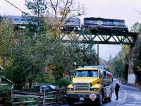 For a few years I made the effort to go out mainly for the fall and winter “Credit Valley Explorer” trains. It was hard to take a bad photo on most of the line with its scenery and deep history. Definitely one of the lines in Southern Ontario I miss the most today. One by one the branchlines that connected to the subdivision vanished into history and freight traffic went on a steady decline well after passenger service ended. Cando did what it could to satisfy the customers that remained but in the end it wasn’t enough. The tour trains on the other hand were a huge success often selling out. But when Orangeville lost interest in the line nothing could save it and today the line is abandoned but still mostly intact. I always tried to get shots of the large Forks of the Credit bridge but it wasn’t an easy task. Limited parking and tight angles didn’t help but this day lucky timing prevailed. The passing tour train catches the eye of a fuel truck driver filling a local home as the veteran GP9 rolls across the bridge. 