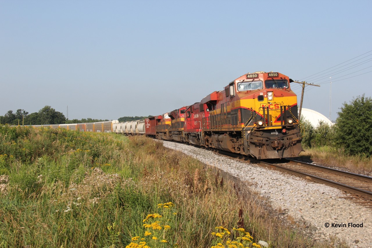 What I think was CPKC 134, screams around the bend at Dumfries Rd. between Ayr and Cambridge with 4-units, mostly KCS and one CP geep. Unfortunately, one motorist was not in her right mind and wouldn't back up off the crossing until the very last minute.