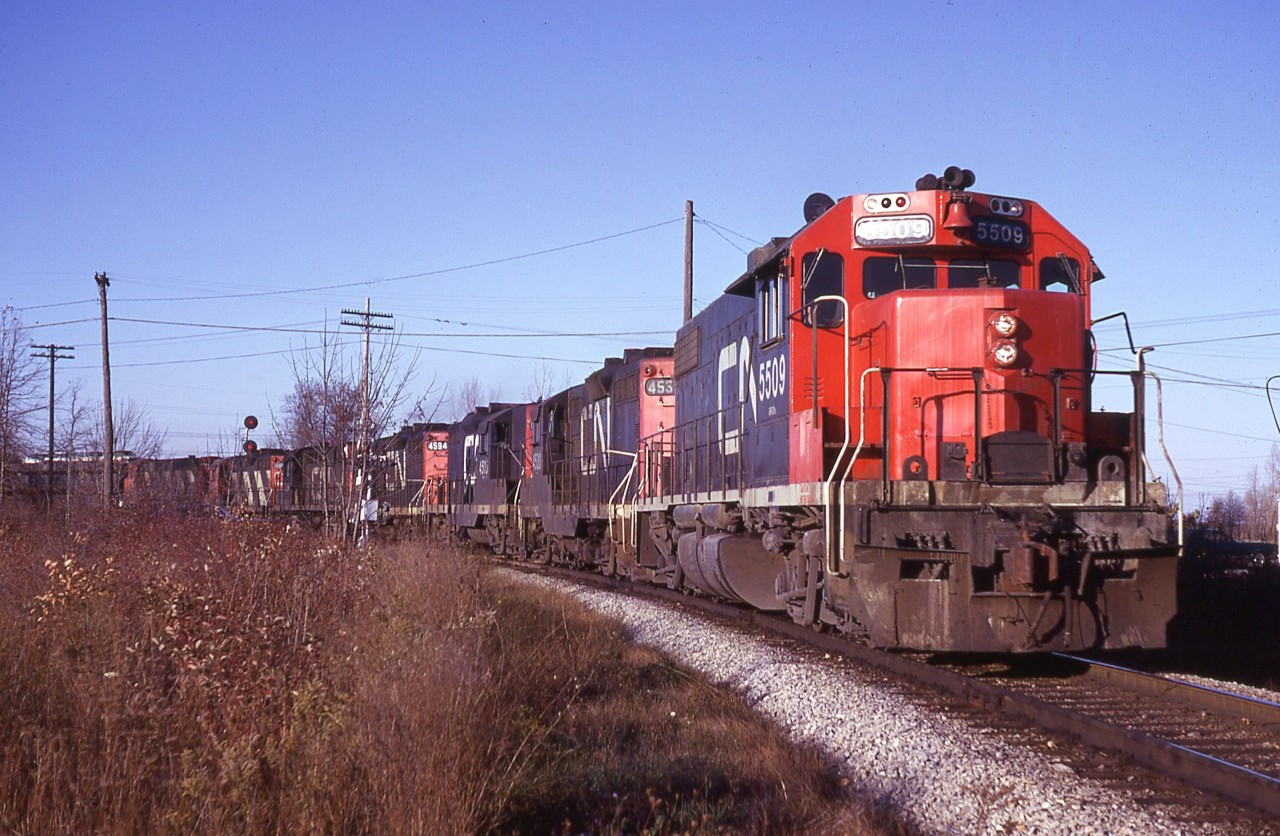 It is easy enough to understand why I miss morning trains like this one. But, in the name of progress, this entertaining fleet of geeps has been replaced by a couple of 4400 HP behemoths that now parade up and down the Grimsby sub every day.  Not much variety any more.
That looks a bit like an M-420 as last unit on this lashup.  Pity I did not have a chance to take down numbers.