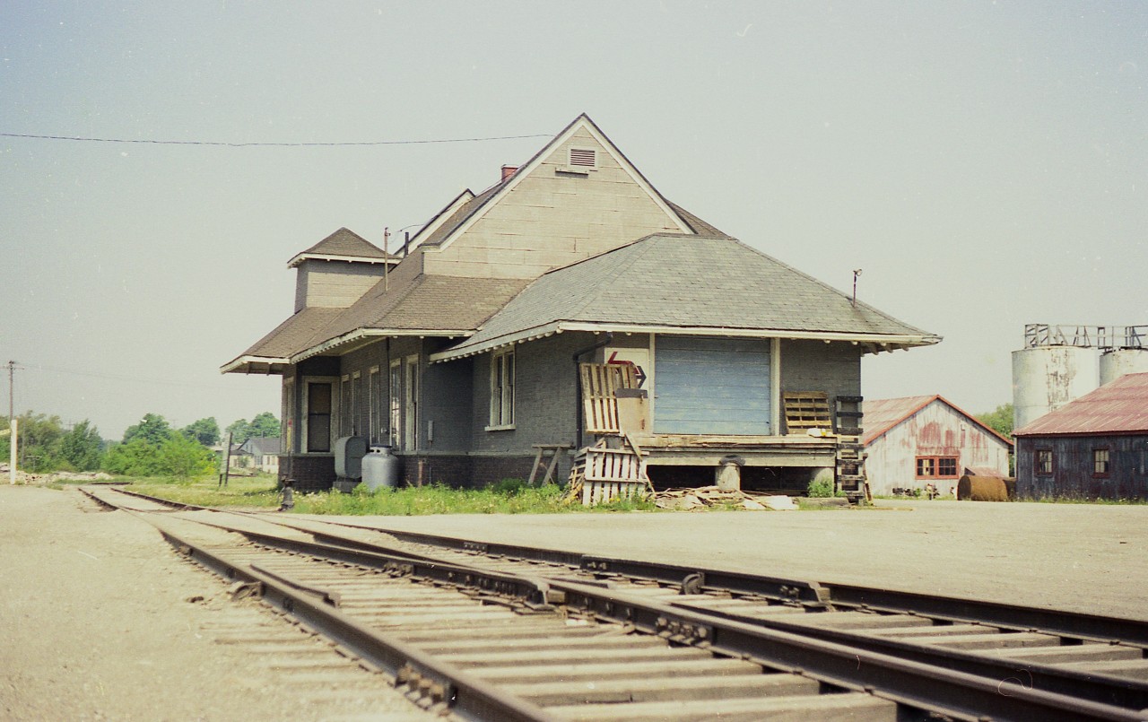 Nothing glamorous about the backside.  Thats the first thing that comes to mind looking at an image of the old CN Wingham station from the rear. At the time of the photo, this structure was occupied by Harkema Express, a trucking outfit. Tracks ran on both sides of the building back in the day. Passenger service ended in 1973 and the line abandoned in 1991. Currently the old station has been restored and in use.