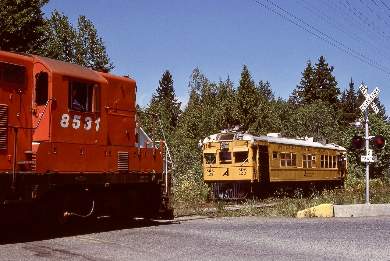 On Vancouver Island, the north end of the siding at Shawnigan on CP’s E&N Victoria subdivision crossed Renfrew Road at the north end of Shawnigan Lake, an area known as Mason’s Crossing for a nearby convenience store. On Tuesday 1977-06-07 at 1215 PDT, that is where Sperry car SRS 127 tucked away in the siding to meet northward freight train No. 51 led by GP9 CP 8531.