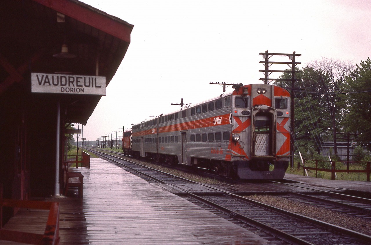 Pity it is a rainy afternoon, but still nice to catch CP 4070 with commuter bi-levels heading eastward toward Montreal.  I'm wondering when the nice old Vaudreuil-Dorion station lost it's life.  Anyone?