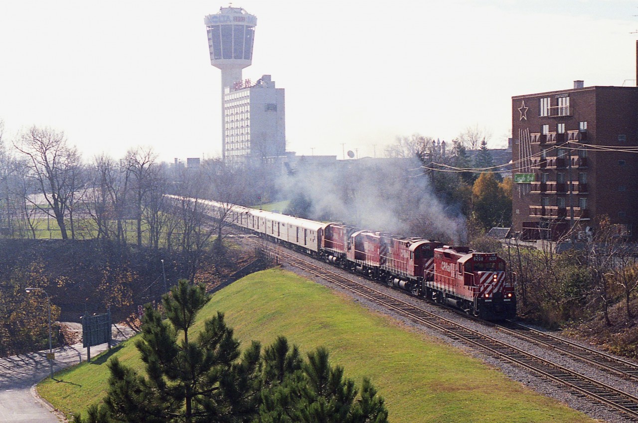 This, the last circus train seen in these parts, ran in late 1988. The image shows CP 8208, 4245, 8212, 4222 and a long train going by the Skylon Tower on its way to the border. (Ringling Bros and Barnum & Bailey)
What is so interesting is how this area has changed to the point of being almost beyond recognition. On the left in front of the trees is Murray Hill and beyond the trees is the present day casino!!  All signs of the double track line have been gone for many years, having being torn up in 2001.
I posted a 4x5 speed graphic shot of this train some years ago. This one is with a 35MM camera, and the same problem reared its ugly head in both shots.  Severe backlighting.  Couldn't be helped.