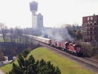 This, the last circus train seen in these parts, ran in late 1988. The image shows CP 8208, 4245, 8212, 4222 and a long train going by the Skylon Tower on its way to the border. (Ringling Bros and Barnum & Bailey)
What is so interesting is how this area has changed to the point of being almost beyond recognition. On the left in front of the trees is Murray Hill and beyond the trees is the present day casino!!  All signs of the double track line have been gone for many years, having being torn up in 2001.
I posted a 4x5 speed graphic shot of this train some years ago. This one is with a 35MM camera, and the same problem reared its ugly head in both shots.  Severe backlighting.  Couldn't be helped.