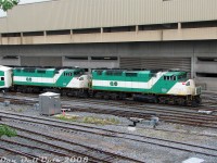 What's better than one GO Transit F59PH? Twins! GO 553 and 559, part of the same 1990 order from GMD (<a href=https://cptdb.ca/wiki/index.php/GO_Transit_520-568#Specifications><b>548-561</b></a>), arrive inbound at Toronto Union Station with afternoon Lakeshore line train #912. The double F59's were mostly used for weekend Lakeshore runs, but a consist or two would often make it onto the weekday equipment cycle.<br><br>Becoming familiar with GO's equipment cycling made it easy to catch triple the afternoon trains in one visit: at the time there was an afternoon equipment change-off for two of the all-day Lakeshore line runs. This consist as #912 would arrive then depart Toronto to eastbound to Oshawa as usual, and come back as #917 only as far as Union Station. Another new consist would be waiting at Union, deadheaded from Willowbrook, to take over from #917 on the adjacent platform. Once the passengers had transferred trains, the new consist as #917 (today with F59PH 560) would depart in service, and the previous #917's consist would deadhead to Willowbrook as an equipment move. The same thing happened with another new consist taking over for train #919 an hour later.<br><br>Knowing all this, it was easy pickings shooting the new equipment move inbound from Willowbrook, it departing westbound as the new in-service train, and the old consist departing out-of-service for Willowbrook. Twice, if you wanted to wait the extra hour out.