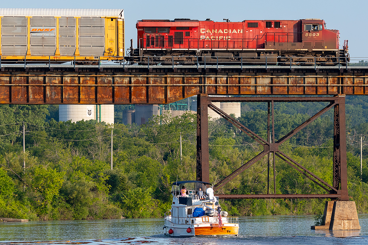 CP 8803 leads a slow eastbound across a busy morning on the Trent River.