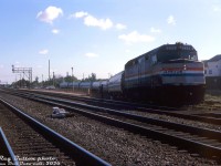 Here's a neat one from Reg: unconventional loading at the VIA/CN Burlington Station at Burlington West. For some reason the mainline tracks couldn't be used (might have something to do with the track workers by the station in the distance), so the morning VIA-Amtrak "Maple Leaf" from Toronto to the states has to make a minor reroute around the station and load on the back track. Seen here paused for its station stop is Amtrak F40PH 228 leading seven Amfleet cars, sitting at an odd angle, with passengers loading by the last car. Anyone know the incident?
<br><br>
<i>Reg Button photo, Dan Dell'Unto collection slide.</i>