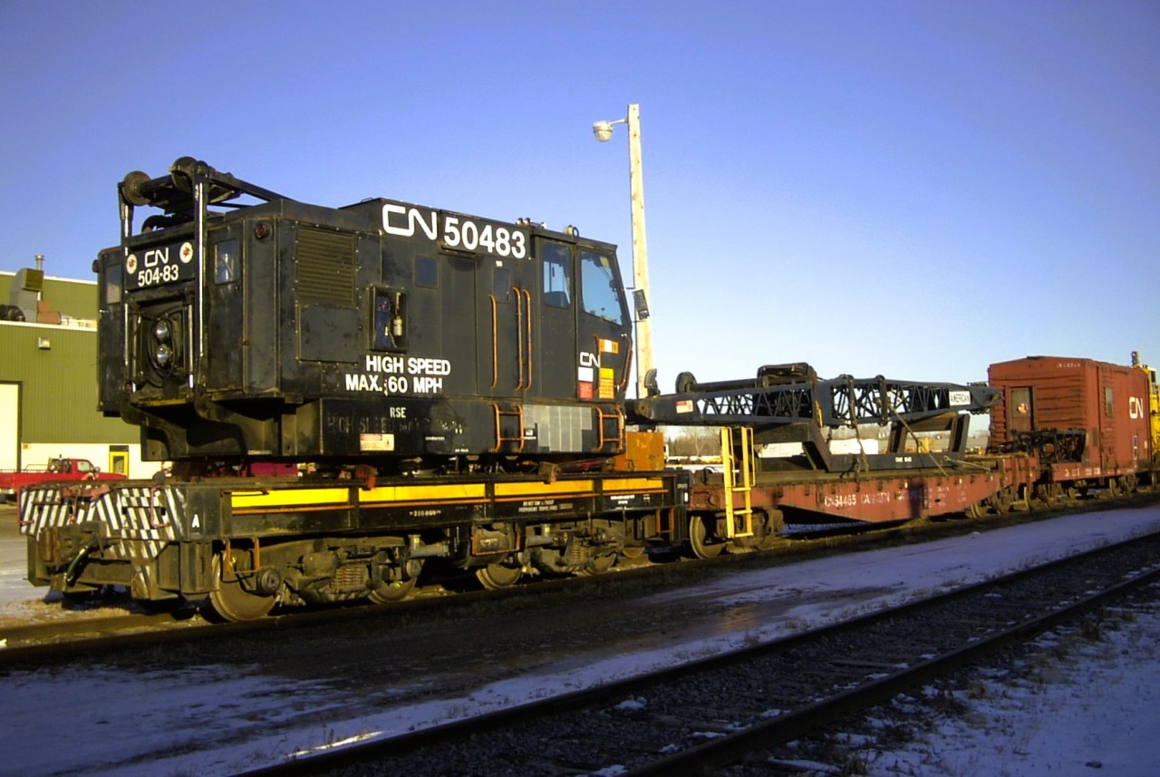 Hook me up!  
CN 50483 is an American model 840 DEH (Diesel powered, Electric traction motors, Hydraulic swing) locomotive crane, serial number L-4353, built in 1986. It was shipped new to CN in Toronto, ON in April 1986. 
It is seen here all tied down and ready for in-train transit to its next work location in the yard at CN's Transcona Work Equipment repair facility after major repairs were completed.