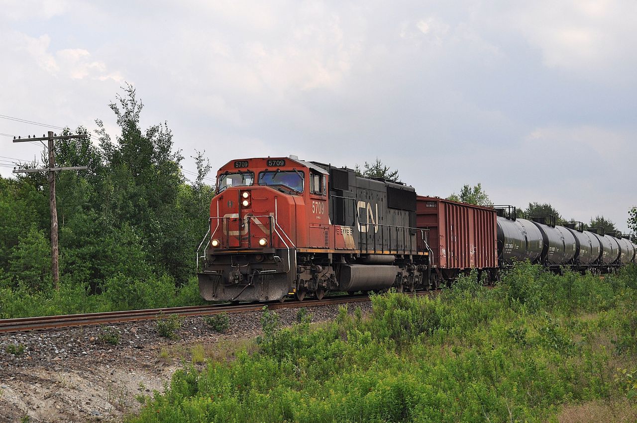 CN SD75i 5709 is the sole power on a westbound empty ethanol train as it approaches Bodson Drive in Hanmer, Ontario on June 29, 2014.