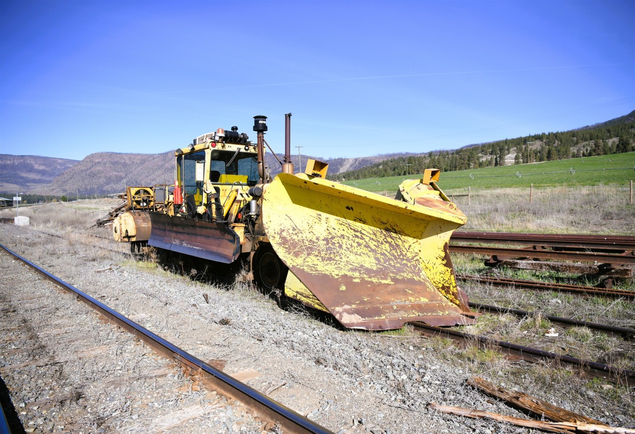 Feeling and looking a little out of place  
On a clear and warm April 18, 2025 morning, snow gear equipped CN 612-50 a Kershaw Mfg. 46-6-1 combination ballast regulator/snow fighter, serial number C46-420-98, built in 1998, sits parked on a dead-end back track at Westwold, BC Mile 37.8 CN Okanagan Sub. on April 18, 2025. 
This Work Equipment machine was built new at the Kershaw Mfg. plant in Cornwall, ON in 1998.