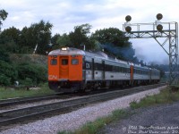 A trio of CN Budd RDC cars, lead by RDC-3 6351, head westbound through Bayview Junction on the Oakville Sub, likely enroute down the Grimsby Sub to Niagara Falls. The trailing car is a 6000-series cabless RDC-9 (single stack for single engine), followed by an RDC-1 in the 6100-series.<br><br>CN and later VIA had a habit of converting their RDC-3 cars (Baggage/RPO/coach) into RDC-1 (coach) or RDC-2 (baggage/coach) configurations for more seating. CN 6351 changed hands to VIA, operated for a few years as an RDC-3 until it was rebuilt as an RDC-2 numbered 6225 in 1984. Eventually it was retired and sold to CAD Rail (likely scrapped).