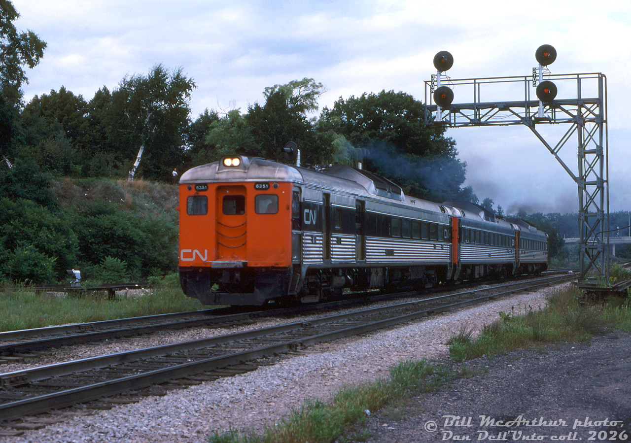 A trio of CN Budd RDC cars, lead by RDC-3 6351, heads westbound through Bayview Junction on the Oakville Sub, likely enroute down the Grimsby Sub to Niagara Falls.
CN, CP and later VIA had a habit of converting their RDC-3 cars (Baggage/RPO/coach) into RDC-1 (coach) or RDC-2 (baggage/coach) configurations for more seating. CN 6351 changed hands to VIA, operated for a few years as an RDC-3 until it was rebuilt as an RDC-2 numbered 6225 in 1984. Eventually it was retired and sold to CAD Rail (likely scrapped).