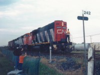 Once I learned of Brighton's most infamous railfanning spot <a href="http://www.railpictures.ca/?attachment_id=59626"> (click here from my first trip the summer before to Memory Junction) </a> I started to make a few stops whenever I headed east to go camping deep in the heart of Prince Edward County. This night, again proved to be eventful. I'm not sure of the circumstances, but CN 4805, 5504 and two other unidentified units were backing up to their train. They proceeded east about half hour of snapping this photo. 
<br>
<br>
The conductor gets a friendly wave from a father and son, as they head back to their train. That's the purpose of Ralph Bangays vision, I think. Making memories, watching trains. Doesn't get any better than this, does it?