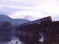 CN RS18 leads a six-car commuter train over the Richelieu River slowing for its Beloeil station stop. On this last day of August 1984, the train faces an uncertain future--it has not been included in the take over of the Deux Montagnes and CP Lakeshore commuter trains by the Montreal Urban Community (MUC) and, indeed, this train and its evening counterpart (No. 900) will make their last runs four years from now (9 September 1988).