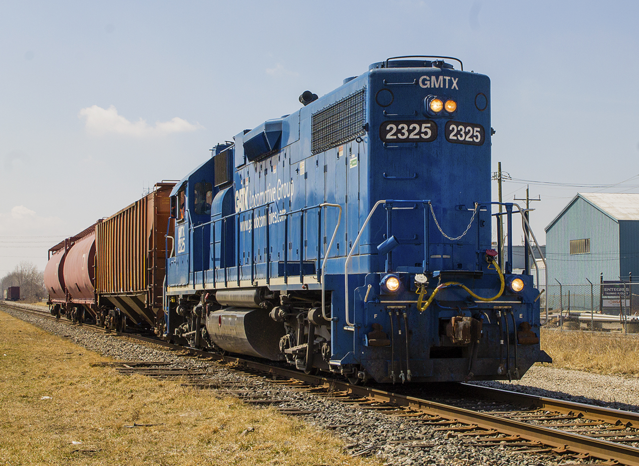As evidenced in my previous photo showing  CPKC Local H89 , sometimes you just have to shoot what you get. In my opinion, locally CN has had more interesting mixes of power. Here, GMTX 2325 is leading CN local 514, in all of its painted blue glory - long hood forward, as it passes by former uard sidings as it exits town.