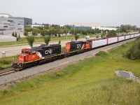 Rolling past the St. ALbert (city) sign, that's not the station name here--it's Campbell Park...Nonetheless, the crew will soon be calling the RTC to report that they are clear of OCS limits on the former NAR Westlock sub and Walker Yard to either get yarding instructions or learn that they are being held out due to congestion. L59051 originated in Smith, AB and has 16 loads and 89 empties, including a long cut of empty Herzog ballast cars. A pair of SD40-2s lead the train--5367 (originally built for the Missouri Pacific in 1973 and acquired by CN from Union Pacific in 1994) and comfort cab equipped 5265 (built new for CN in July 1975).