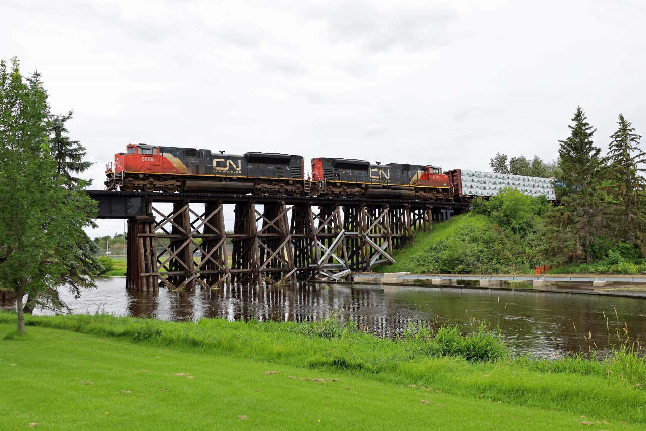 L51641 from Whitecourt gingerly crosses the swollen Sturgeon River in St. Albert with SD70M-2s 8888, 8931, and 47 cars. (Central Alberta has received record amounts of rain this summer.)
