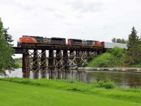 L51641 from Whitecourt gingerly crosses the swollen Sturgeon River in St. Albert with SD70M-2s 8888, 8931, and 47 cars. (Central Alberta has received record amounts of rain this summer.)