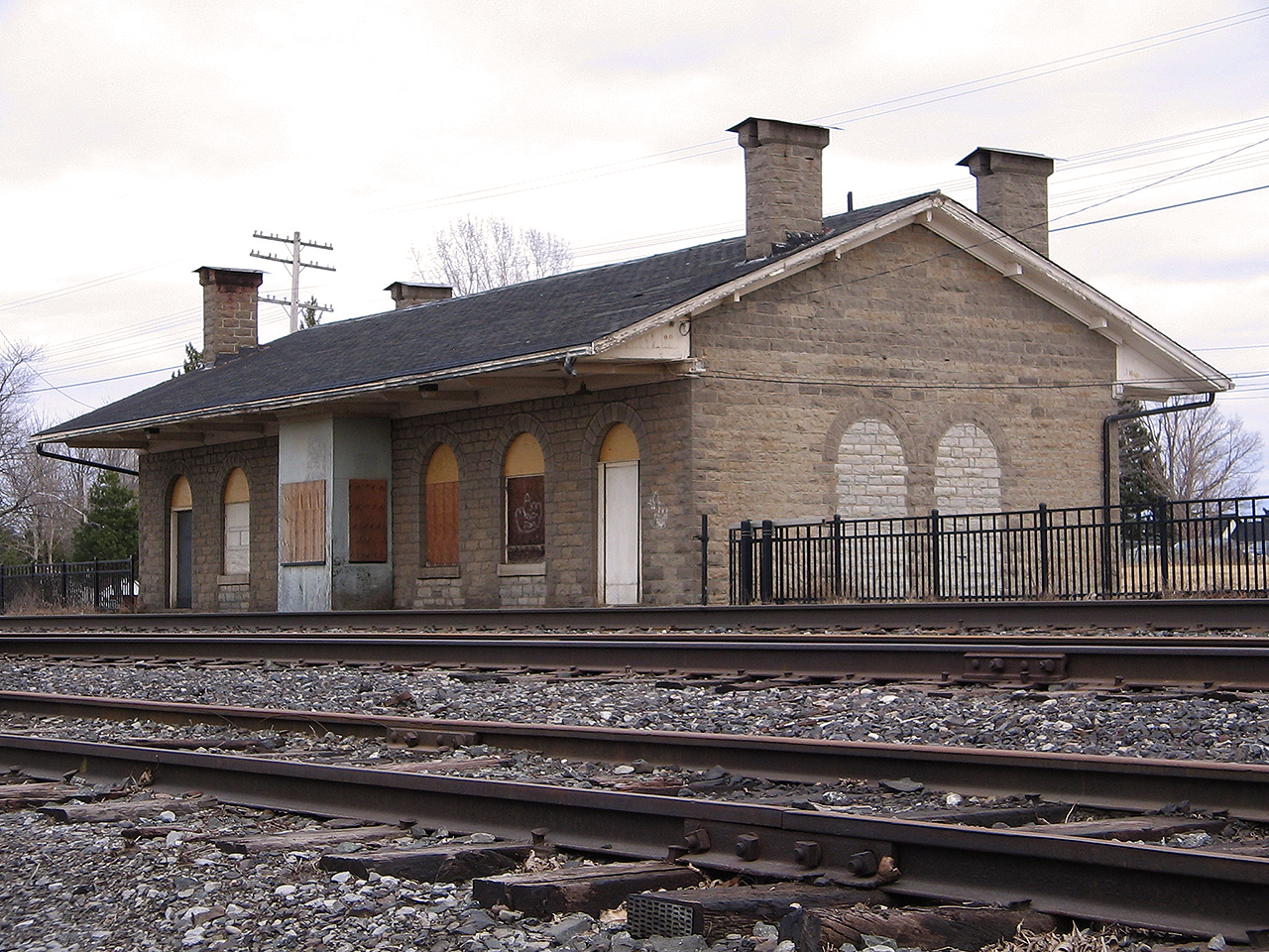 Inspired by Elizabeth A. Wilmore's photo from one of her publications, I decided to replicate her beautiful 3/4 angled shot of the old Grand Trunk station. But, sadly the future of this building was looking quite bleak on this cold March day. Both VIA and a commercial business had closed up shop, and left the station all closed up.


A shame really. However, along came the  the Grenville County Historical Society  needing a new home. Through countless volunteer hours, they have rejuvenated this once busy station, and have called it home since 2007. Well worth a visit, if you're ever going by. Still a great spot for railfanning too!