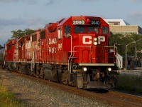 Sometimes, things just pay off. You may not get what you want, but local H89 sure does provide some interesting times. Shown in the golden hour of a setting sun, it's clipping through downtown Chatham having already crossed 7 of the 14 level crossings - at a fairly good pace. While it's on it's way to switch at the ethanol plant out at Ringold (Bloomfield Rd.), it'll stay clear of an eastbound 230 before making it's way home again during its hour spent here.