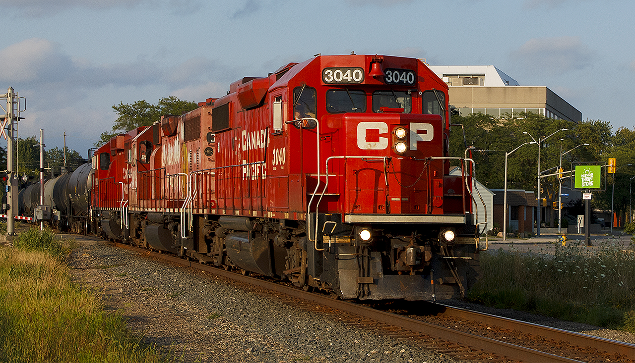 Sometimes, things just pay off. You may not get what you want, but local H89 sure does provide some interesting times. Shown in the golden hour of a setting sun, it's clipping through downtown Chatham having already crossed 7 of the 14 level crossings - at a fairly good pace. While it's on it's way to switch at the ethanol plant out at Ringold (Bloomfield Rd.), it'll stay clear of an eastbound 230 before making it's way home again during its hour spent here.