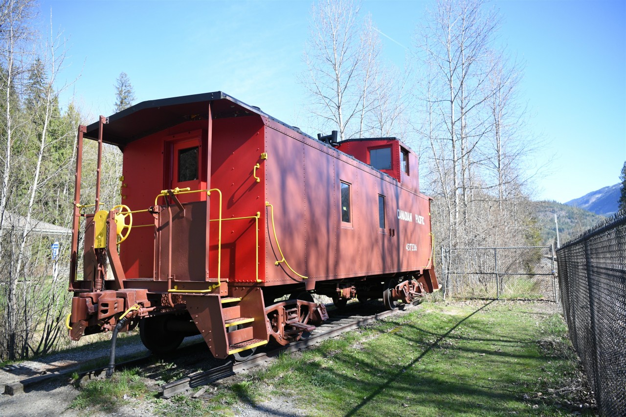 Caged Caboose  
CP 437336 steel sheathed caboose built in 1949 sits on static display behind the Frost fence next to the CP mainline at the 'Last Spike rest stop' in Craigellachie, BC on April 17, 2025.