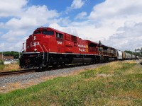 <b>BIG RED AND A SCRIPTED FONT!</b> I can't remember when I shot this photo, other than knowing I was on my lunch break from work. It was also sometime after CP rebuilt their stored SD90 units. But, this day in particular, was one every railfan waited for. There was an eastbound that was going to be coming, with two painted CM&Q units leading the charge. 
<br>
<br>
Here, rebuilt SD70ACu 7043 leads, along with a heritage unit in the vintage CP paint scheme, westbound through downtown Chatham.