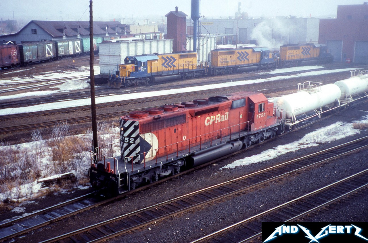 During a foggy morning, CP SD40-2 5752 switches cars as three Ontario Northland Railway SD40-2’s wait in the background at their shop in North Bay, Ontario.