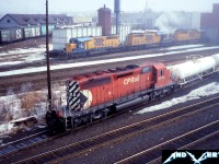 During a foggy morning, CP SD40-2 5752 switches cars as three Ontario Northland Railway SD40-2’s wait in the background at their shop in North Bay, Ontario. 