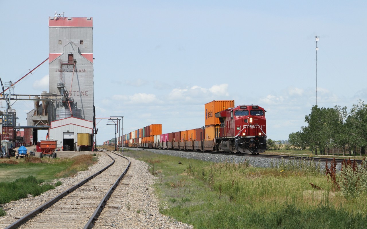 CP 7552 ( GE ET44AC )eastbound through Milestone Saskatchewan passing the grain elevator.