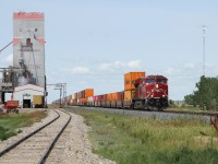 CP 7552 ( GE ET44AC )eastbound through Milestone Saskatchewan passing the grain elevator.