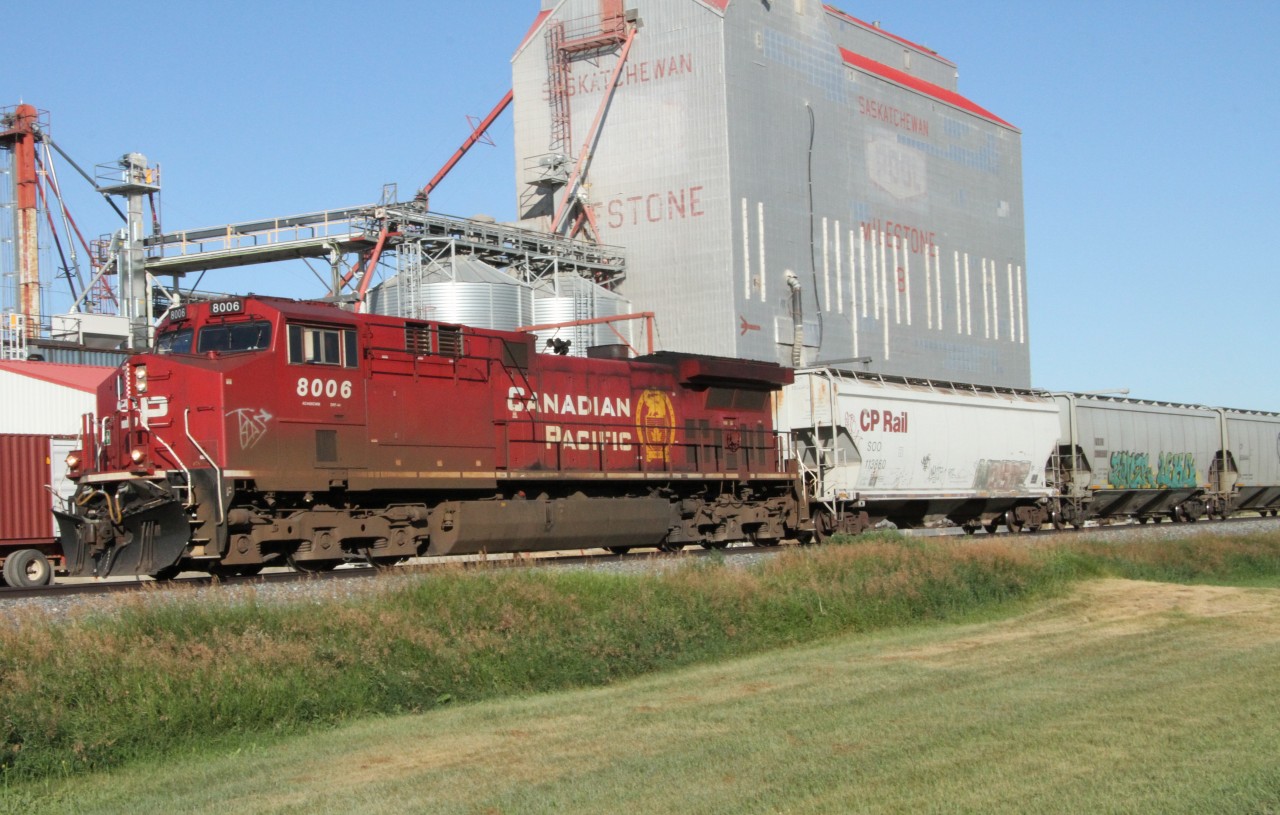CP 8006 ( GE AC4400CWM ) heading eastbound past the grain elevator, through Milestone Saskatchewan.