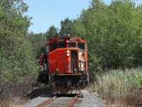 L554 disappearing into the vegetation pushing 36 empty hoppers down the Cement Lead to the Ash Grove Mississauga facility.