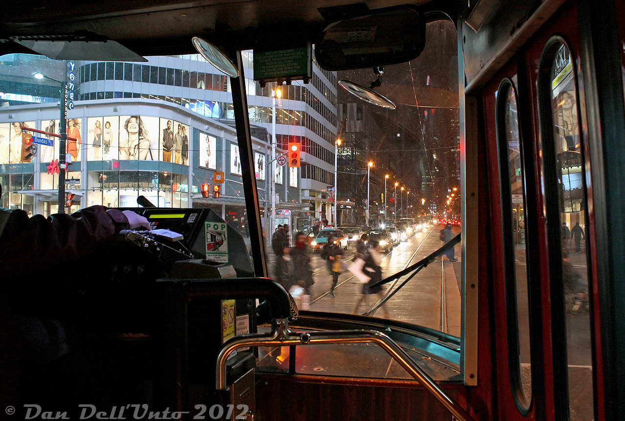 The experienced hand of the streetcar operator of TTC CLRV 4101 sits at the ready to rip off a paper transfer for any last-minute borders aboard this 505 Dundas streetcar, as we sit at the lights at the busy intersection of Dundas Street and Yonge Street waiting for the mad pedestrian traffic scramble to end. The 9pm traffic tonight is a little heavy along this stretch of Dundas by the Eaton Centre and Ryerson's Ted Rogers School of Management, and some March winter flurries still linger, but we're warm inside for the short ride across Dundas to University Avenue.