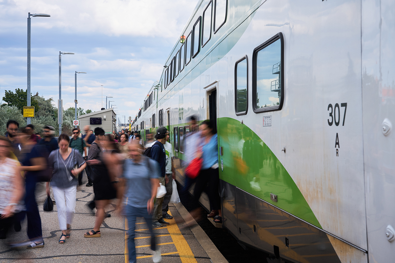 Passengers are seen disembarking their evening GO train at Etobicoke North station and walking to the parking lot to drive the remainder of the trip home or to catch a bus on Kipling Ave below.