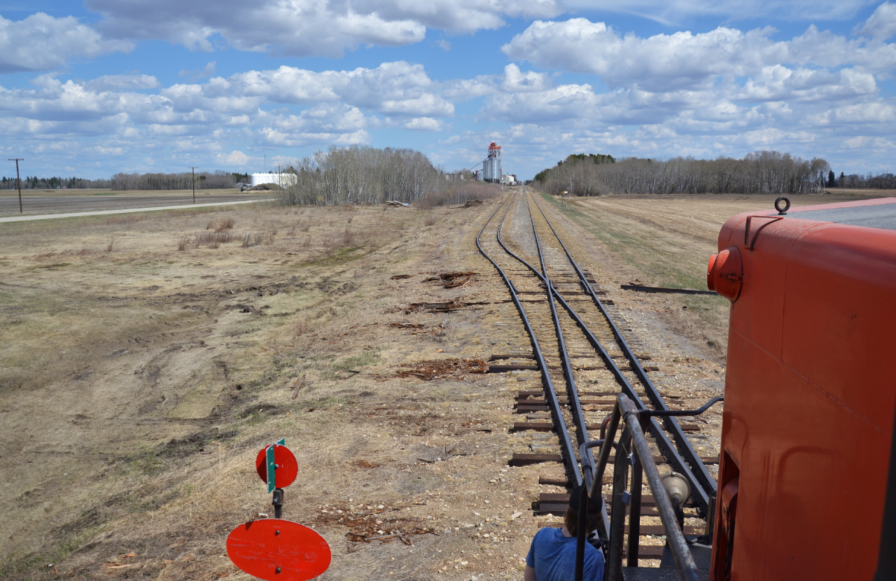 End of the line.

This is now the terminus of the former CPR White Fox Sub, roughly half a mile to the West of the town of Choiceland, the tracks once had continued for another 500~ odd feet before the official end which was used for car storage. Today, the tracks end just before what I believe is Road No.488, with the amount of un named dirt roads in the province, this is an educated guess. 

Out of picture behind the engine is the new engine shop that the TRR had built to house the GDM1. Driving along highway 55 from Nipawin to Prince Albert or vise versa, the White Fox Sub will parallel the highway from Meath Park to Choiceland where the tracks resume into Nipawin. 

Its an incredibly scenic and picturesque drive as you leave Prince Albert along the North Saskatchewan river and begin to see the transition from the Boreal Transition to the Uplands. Keep an eye out for the numerous abandoned smaller trestles and bridges that scatter the former ROW, I tried to find some old relics, albeit to no avail.