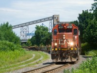 CN 4731 (still sporting a real bell) leads a transfer out of the Port of Montreal, with bad ordered well cars up front. They will be repaired at the nearby Pointe St-Charles Yard and then return to the port.