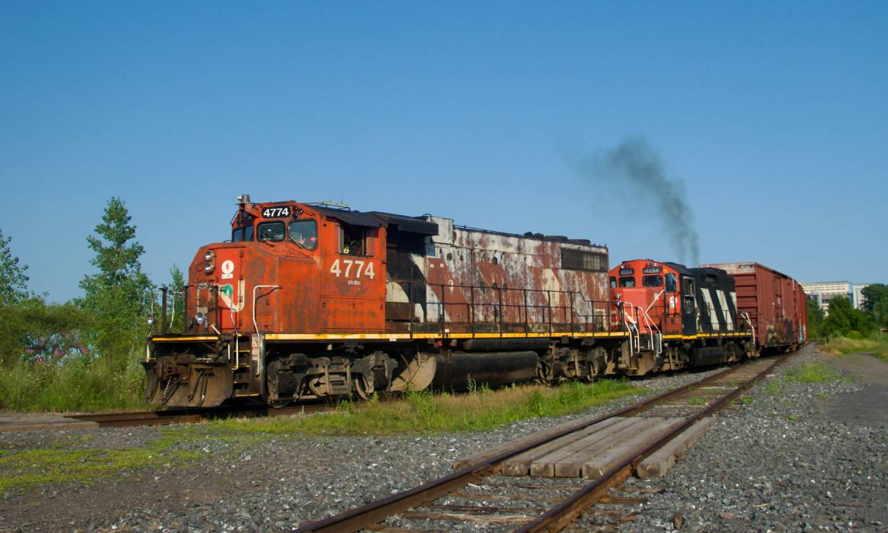 One of CN's more horrid looking GP38-2W leads as CN YRP003 backs up before heading towards Getpaq with three boxcars.