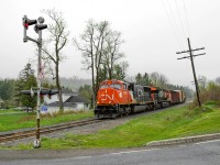 Fresh SD75IACC #8308 leads a very short train 562 in the small town of Saint-Noel, as it heads to Campbellton where hopefully they will take a longer train down to Mont-Joli. The weather that day wasn't perfect, being very foggy, but the power made it worth the trip. I also could hear the old crossing bell's one last time before they replaced it moments later, CN are saddly replacing them with electronic ones regardless if they are in working condition or not.