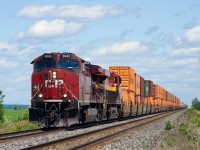 CPKC 133 is approaching the diamond with VIA Rail's Alexandria Sub at De Beaujeu with dirty CP 8045 leading.