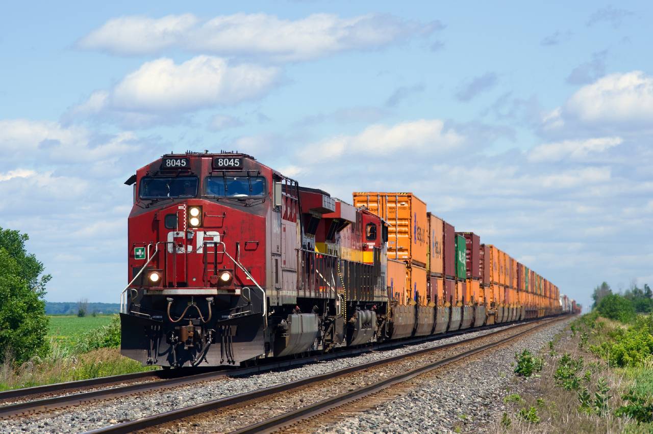 CPKC 133 is approaching the diamond with VIA Rail's Alexandria Sub at De Beaujeu with dirty CP 8045 leading.