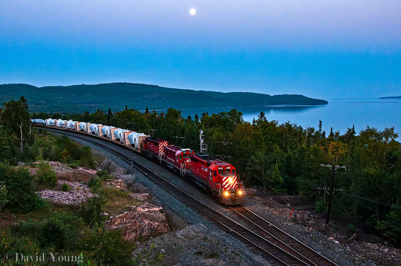 A follow up to my one of my earliest uploads. Around 2010-11 timeline CP was contracted to haul windmill towers and components from southern Ontario (Windsor, if memory serves correct?) to Alberta. This days edition was symbolled "785" and had a one of two type loco for the railroad along for the ride. The crew is roughly 10 miles into their trip over the Nipigon Sub about to hit the switch pionts of Selim West as the blue hour is setting in. CP 5912 West with sister SD40-2 6079 sandwiches the testbed Genset 3GS21B-DE 2101 sandwiched admist the trio. A decade and a half later, the siding at Selim has been extended west to a capacity of roughly 14,000', up from the previous capacity of roughly 8140'.