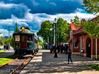 Elgin County Rail Museum's restored L&PS Car 14 is right back where she belongs. A rare mileage charter involving the Port Stanley Terminal Railway and the Museum came together beautifully with three runs taking part over the day. The runs originated out of the London & Port Stanley replica staiton in downtown St. Thomas.  The morning run to Port Stanley was a sold out success, the second run for all volunteers involved ran from as far as Whytes and return while a third and final trip ran Port Stanley in the afternoon sold out as well. It brought out the cameras as well.<br> Pushed by Port Stanley Terminal Railway's "Winnie", LPS 14 rolls into the replica station downtown St Thomas with rp.ca's contributers <a href="https://www.railpictures.ca/author/kylestefanovic">Kyle Stefanovic's</a> son framing up the old streetcar. A shame this stretch of rail which was relaid only sees use a handful of times a year. It is great seeing the Port Stanley Terminal and Elgin County Museum jointly operate within the city and I for one, wish they could find a formula which would see more frequent operations within the city limits.