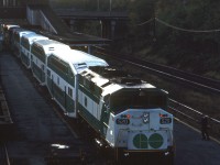 GO Transit 520 sits at the old <a href=http://www.railpictures.ca/?attachment_id=47320><b>CN Hamilton (James Street) station</b></a> as a crew member down on the platform looks on. This appears to be an evening shot, suggesting the train had just finished its run from Toronto to Hamilton and was preparing to depart in push-mode back east. At the time, CN's car department was still using some of the station tracks and platforms for freight car repairs (imaging getting off your GO train onto the platform next to a giant set of freight car wheels! That wouldn't fly with the Metrolinx liability department today).<br><br>In less than two years, GO would leave James Street station for the newly renovated TH&B station in downtown Hamilton in early 1993 (<a href=http://www.railpictures.ca/?attachment_id=36825<b>Amtrak and VIA</b></a> had already left in 1992), and LIUNA would purchase the vacant station for use as a banquet hall. GO would eventually return to this area of Hamilton in 2015 with its new <a href=http://www.railpictures.ca/?attachment_id=20100><b>West Harbour GO station</b></a>, built a stone's throw away from the old James Street station.<br><br><i>Original photographer unknown, Dan Dell'Unto collection slide.</i>