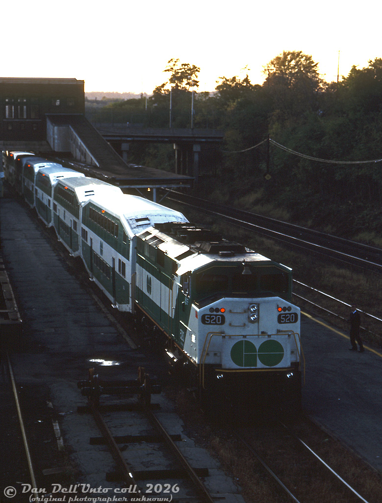 GO Transit 520 sits at the old CN Hamilton (James Street) station as a crew member down on the platform looks on. This appears to be an evening shot, suggesting the train had just finished its run from Toronto to Hamilton and was preparing to depart in push-mode back east. At the time, CN's car department was still using some of the station tracks and platforms for freight car repairs (imaging getting off your GO train onto the platform next to a giant set of freight car wheels! That wouldn't fly with the Metrolinx liability department today!).In less than two years, GO would leave James Street station for the newly renovated TH&B station in downtown Hamilton in early 1993 (