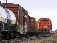 CN local train 559 waits in L'Isle-Verte siding for train 402 to clear, minutes after completing its work at April Lubricants, hidden by 402 in the background. Today, these meets doesn't happen anymore, as 402 doesn't run daily anymore, and train 559 is almost always sent on days which the mainline freights doesn't run. CN 4732 has also since been modernized with an electronic bell and an ekyrail A/C unit.