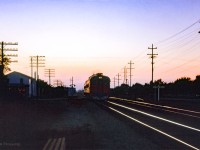 Last light falls on the Hamilton area as an unidentified pair of Budd RDCs slam over the Park Road crossing at the former station site of Grimsby Beach, mile 25.69, headed for Niagara Falls.

<br><br>A busy day:
<br><a href=https://www.railpictures.ca/?attachment_id=52960>Train 77 arriving Bayview</a>
<br><a href=https://www.railpictures.ca/?attachment_id=53821>Train 29 Bayview</a>
<br><a href=https://www.railpictures.ca/?attachment_id=54098>Extra freight eastbound</a>
<br><a href=https://www.railpictures.ca/?attachment_id=53125>Train 77 departing Bayview</a>
<br><a href=https://www.railpictures.ca/?attachment_id=51601>Intercity Limited at Paris</a>
<br><a href=https://www.railpictures.ca/?attachment_id=57748>CNR 6167 over the Grand</a>
<br><a href=https://www.railpictures.ca/?attachment_id=59309>CNR 6167 on the Drumbo</a>

<br><br><i>Scan and editing by Jacob Patterson.</i>