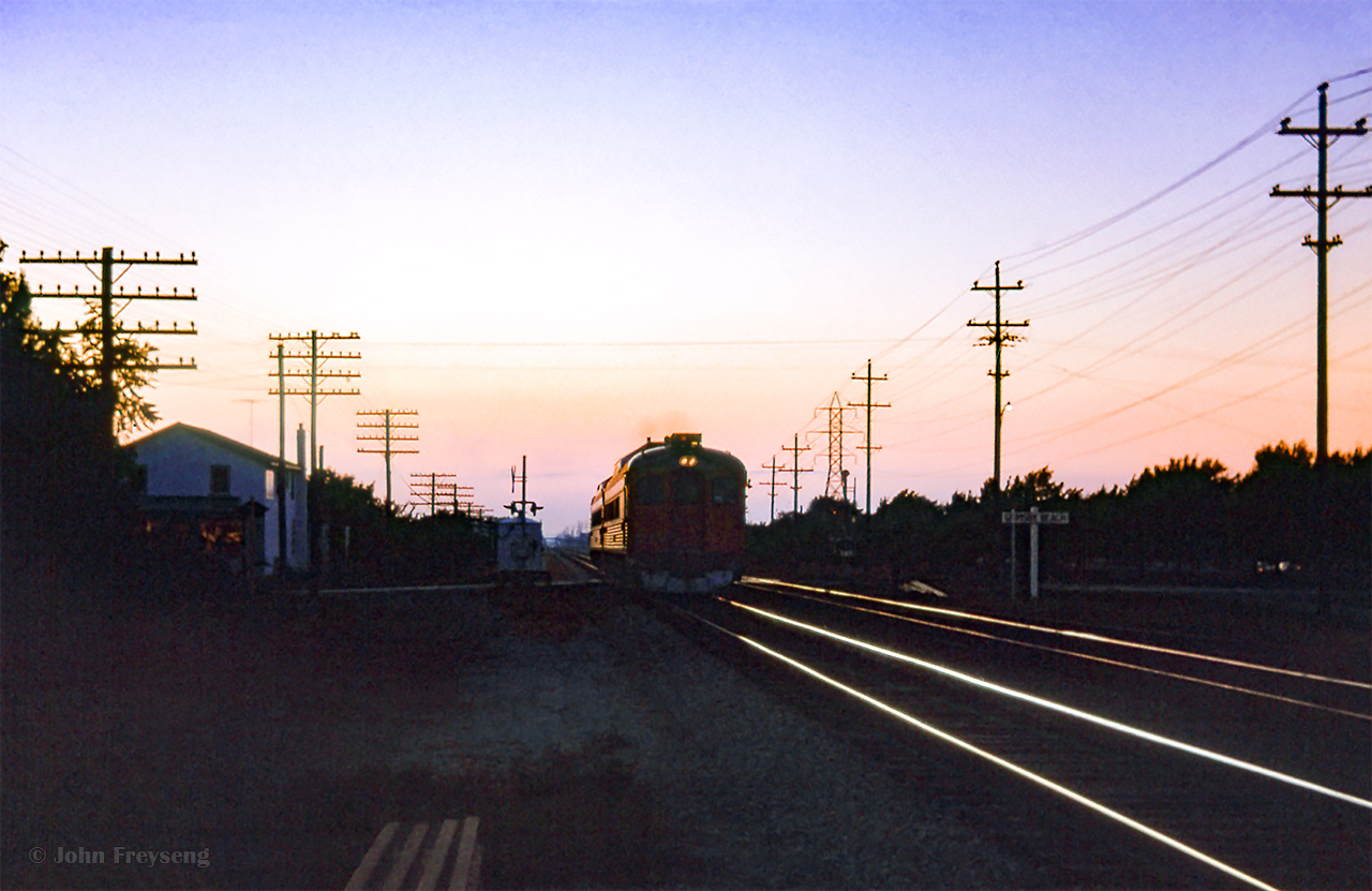 Last light falls on the Hamilton area as an unidentified pair of Budd RDCs slam over the Park Road crossing at the former station site of Grimsby Beach, mile 25.69, headed for Niagara Falls.

A busy day:
Train 77 arriving Bayview
Train 29 Bayview
Extra freight eastbound
Train 77 departing Bayview
Intercity Limited at Paris
CNR 6167 over the Grand
CNR 6167 on the Drumbo

Scan and editing by Jacob Patterson.